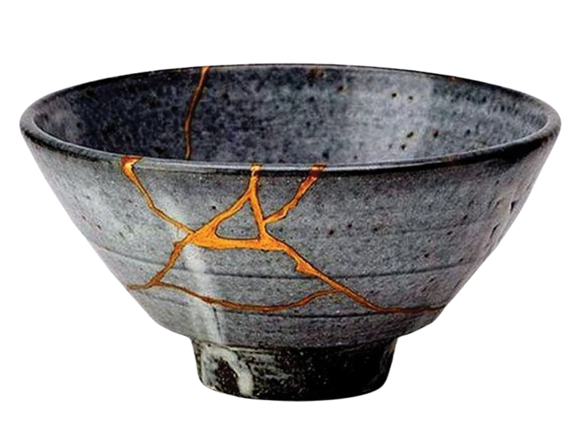 A grey ceramic bowl with its cracks repaired in gold