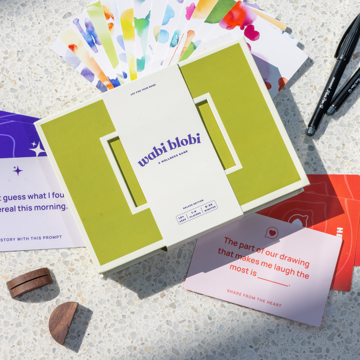 Wabi Blobi Deluxe Edition box open with watercolor blob postcards, prompt cards and art pens