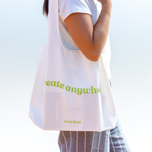 Person carrying the Wabi Blobi Create Anywhere canvas tote bag