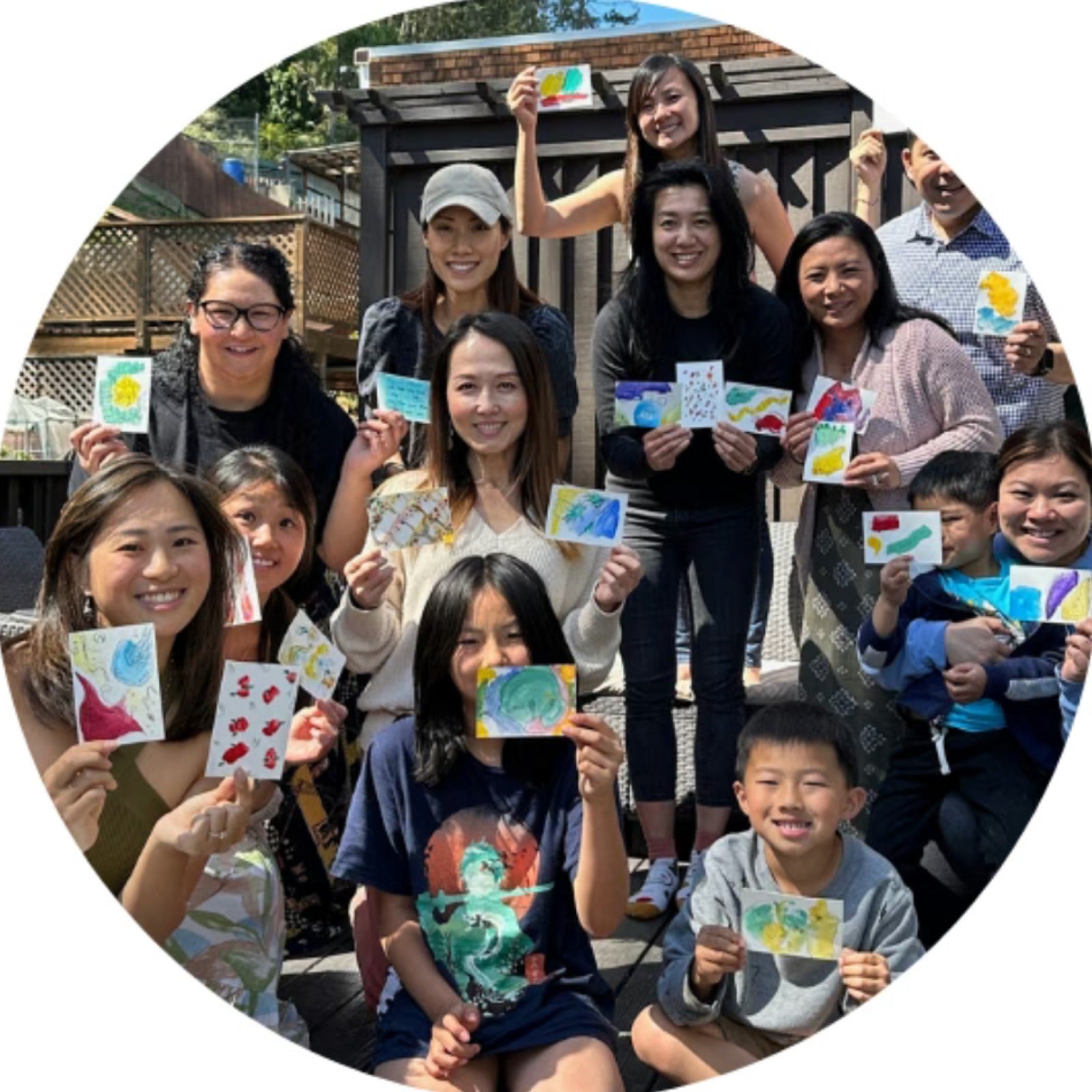 Friends and families holding up their watercolor blob cards at the first prototype party